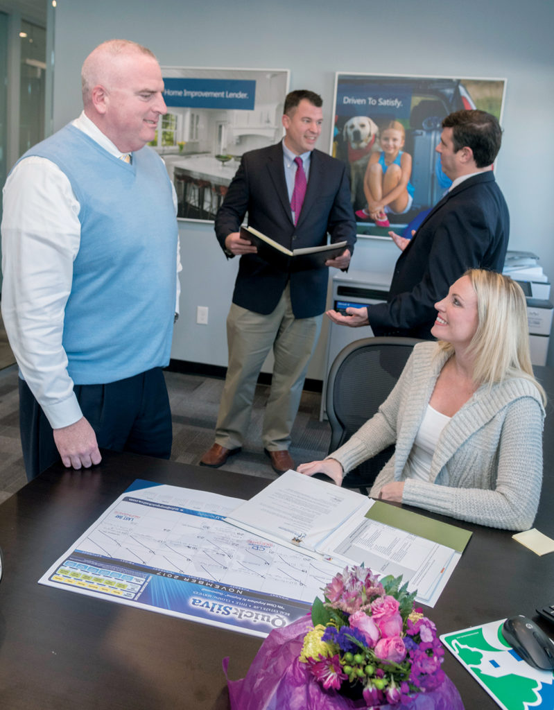 EXPANDING: Home Loan Investment Bank recently opened two new lending offices, in Warwick and Providence. Above, foreground, Kevin Roche, vice president, speaks with Tania Krouse, mortgage adviser, while John Casey, background left, mortgage banker, consults with Brian J. Murphy, chairman and CEO. / PBN PHOTO/MICHAEL SALERNO EXPANDING: Home Loan Investment Bank recently opened two new lending offices, in Warwick and Providence. Above, foreground, Kevin Roche, vice president, speaks with Tania Krouse, mortgage adviser, while John Casey, background left, mortgage banker, consults with Brian J. Murphy, chairman and CEO. / PBN PHOTO/MICHAEL SALERNO