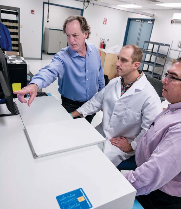 GUIDING RIGHT: From left, John D. Jarrell, founder of BioSci Labs in Coventry; Michael Stone, lab director; Jim Wilkinson, partner at Marcum, corporate sponsor of BioSci, calibrate a new piece of equipment for the lab. / PBN PHOTO/MICHAEL SALERNO GUIDING RIGHT: From left, John D. Jarrell, founder of BioSci Labs in Coventry; Michael Stone, lab director; Jim Wilkinson, partner at Marcum, corporate sponsor of BioSci, calibrate a new piece of equipment for the lab. / PBN PHOTO/MICHAEL SALERNO