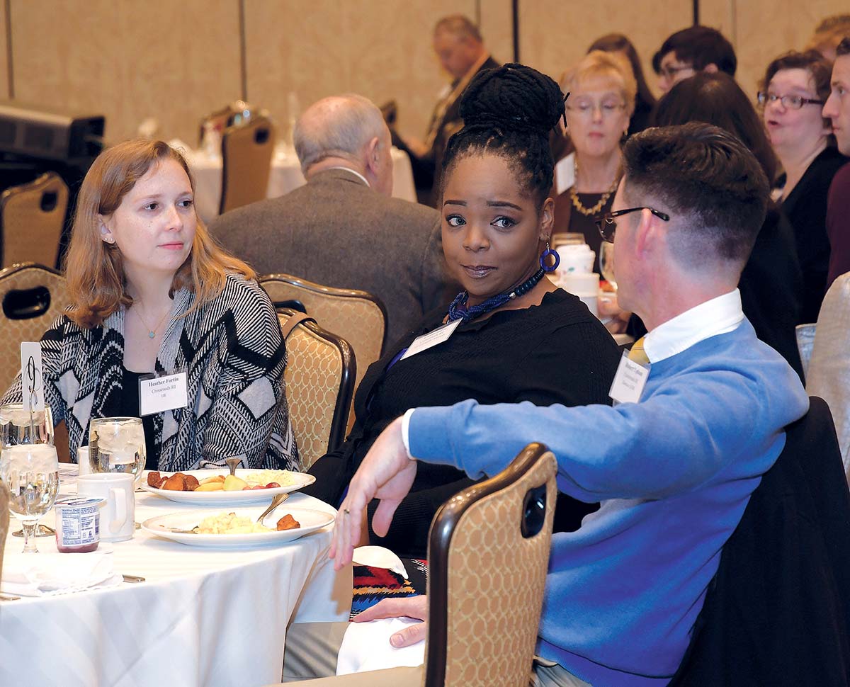 CONVERSING: Crossroads Rhode Island members, from left, Heather Fortin, human resources and individual volunteer coordinator; Cicely Dove, vice president of family services; and Robert Upham, director of human resources, attend the PBN Workplace Excellence, Diversity and Inclusion Summit held Dec. 7 at the Crowne Plaza Providence-Warwick. / PBN PHOTO/MICHAEL SKORSKI