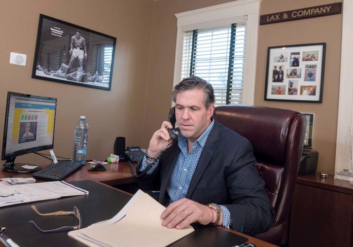 EASY ACCESS: Ryan Alan Lax, owner of Warwick-based financial-planning and life insurance firm Lax & Co., offers his clients ease of access via a phone application through Lion Street, a nationwide partnership group based in Texas. / PBN PHOTO/MICHAEL SALERNO EASY ACCESS: Ryan Alan Lax, owner of Warwick-based financial-planning and life insurance firm Lax & Co., offers his clients ease of access via a phone application through Lion Street, a nationwide partnership group based in Texas. / PBN PHOTO/MICHAEL SALERNO