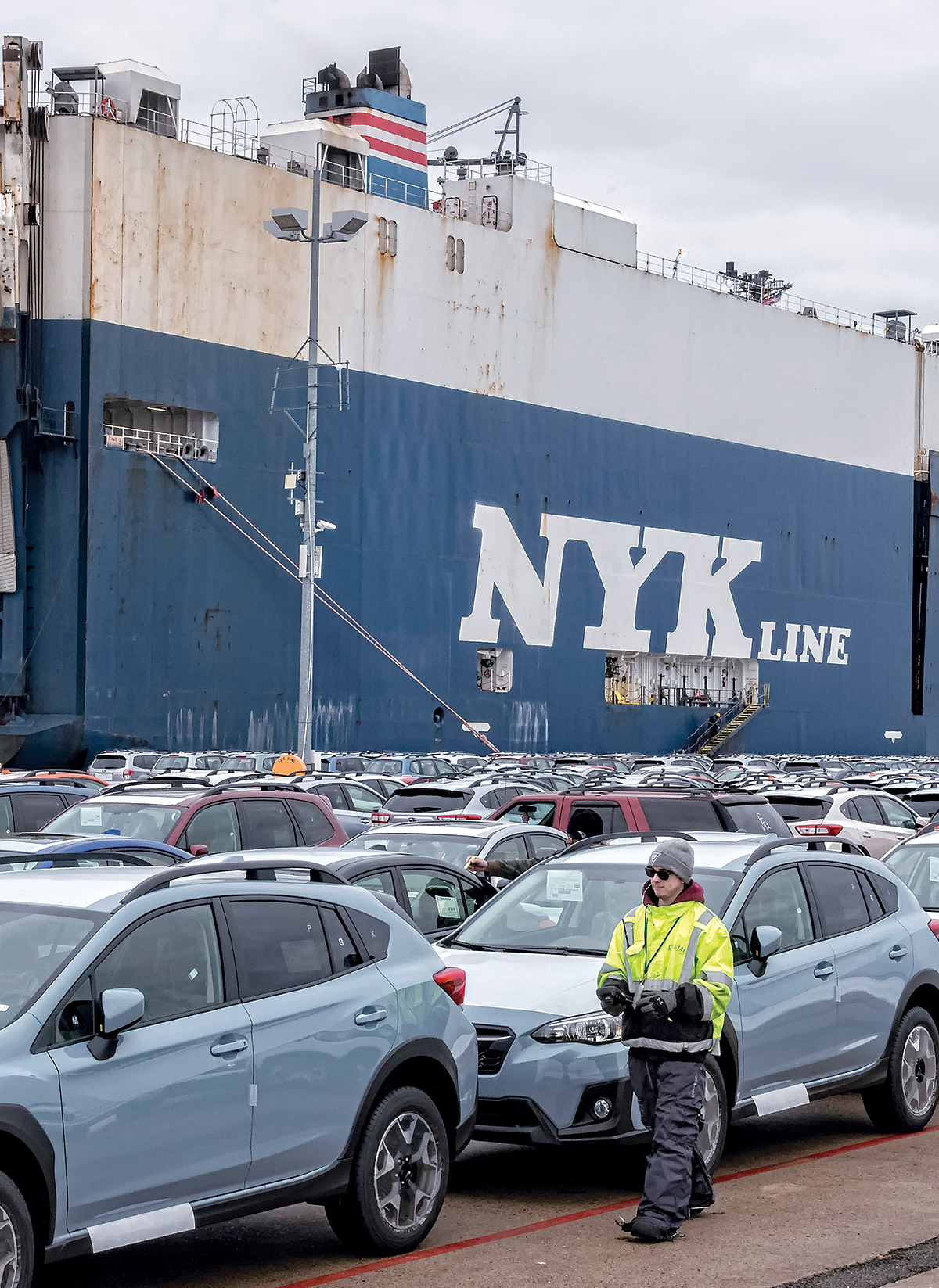 BUSY PORT: Ships unload cars being imported into the U.S. from overseas, at the NORAD facilities at the Port of Davisville in North Kingstown. Daniel Tofdoff, longshoreman, scans and tags vehicles / PBN PHOTO/MICHAEL SALERNO