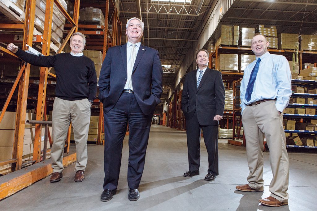 STORAGE SPACE: One of the catalysts for expanding Rhode Island’s existing foreign trade zone to include the entire state, was Warwick Mayor Scott Avedisian, second from left. He wanted to include Dean Warehouse Services Inc., at 745 Jefferson Blvd. in Warwick, with its 600,000 square feet of storage space for imports. Pictured, from left, with Avedisian at the warehouse are company officials Chairman Brad A. Dean, President Joseph R. Iovini and CEO Brad S. Dean. / PBN PHOTO/RUPERT WHITELEY 