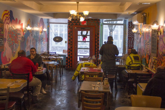 WARM WELCOME: At Brickway on Wickenden Street, just three tables were seated at 9:30 a.m. on the day of the bomb cyclone, Jan. 4. Small business owner Om Devkota says that he often stays open even with blizzard weather rather than lose a day of sales. /PBN FILE PHOTO/ KATE TALERICO