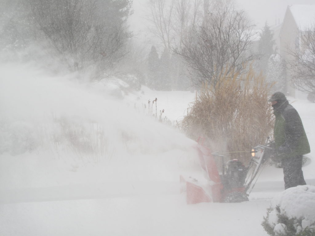 SNOW CONTINUES TO WALLOP Rhode Island with blizzard conditions. Above, a Warwick resident snowblowing his driveway mid-storm. / PBN PHOTO/JANE BLOTZER