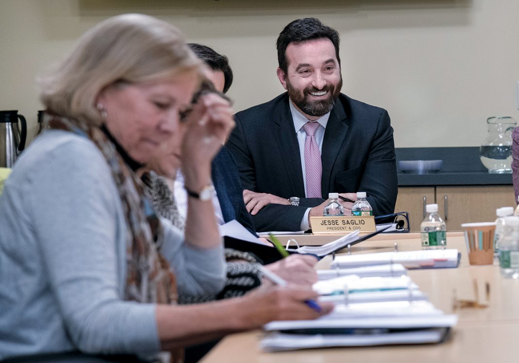 SELLING R.I.: Jesse Saglio, right, the new president and chief operating officer of R.I. Commerce Corp. at a recent public meeting of the agency’s board. He says Commerce will step up its focus on helping local and small businesses this year. / PBN PHOTO/MICHAEL SALERNO