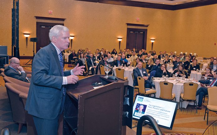 CONCERNED: Keynote speaker Mark W. Everson, vice chairman of alliantgroup, a Texas-based tax-services provider, addresses the crowd at the Providence Business News 2018 Tax Reform Summit. He says the growing budget deficit is a top concern. / PBN PHOTO/ MIKE SKORSKI