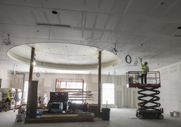 CONSTRUCTION OF THE HOTEL at the hotel at Twin River in Lincoln is near completion. Above, Cory Viera, dry wall finisher for H. Carr, works on one of the ceilings on the first floor. / PBN PHOTO/MICHAEL SALERNO CONSTRUCTION OF THE HOTEL at Twin River Casino in Lincoln is near completion. Above, Cory Viera, dry wall finisher for H. Carr, works on one of the ceilings on the first floor. / PBN PHOTO/MICHAEL SALERNO