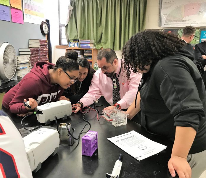 AMGEN INC. brought its Amgen Biotech Experience program to Central Falls High School earlier this month. From left: students Joselinda Evora and Jackeline Martinez; teacher David Upegui; and student Daphne Mulford. / COURTESY AMGEN AMGEN INC. brought its Amgen Biotech Experience program to Central Falls High School earlier this month. From left: students Joselinda Evora and Jackeline Martinez; teacher David Upegui; and student Daphne Mulford. / COURTESY AMGEN