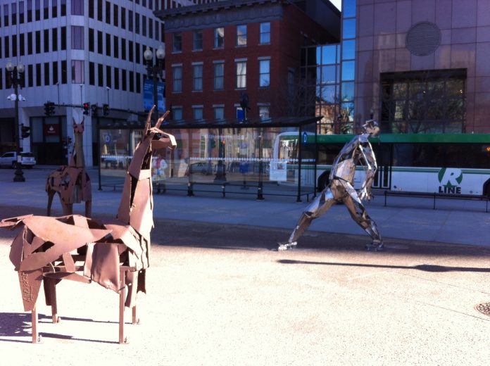 TWO 6-FOOT LLAMAS and a man made of car bumpers are among the scrap art sculptures installed in Kennedy Plaza in Providence. / PBN PHOTO/ MARY MACDONALD