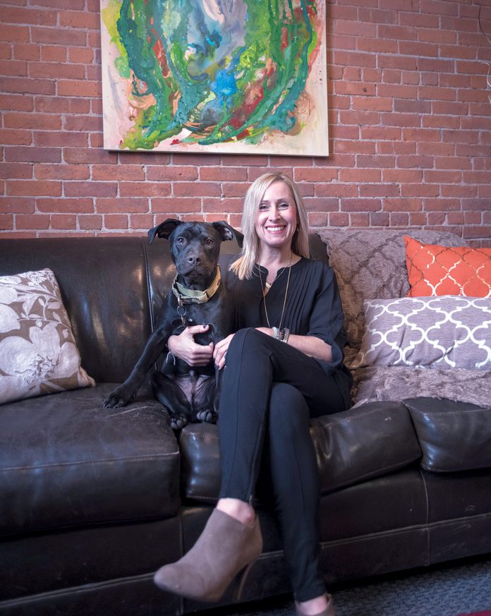 MANY ROLES: Tuni Schartner, owner of TS Consulting, chief marketing officer of The Mill at Lafayette and director of The Hive co-working space, still finds time with her dog Homer. / PBN PHOTO/­MICHAEL SALERNO