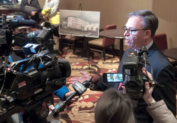 TOUR PREPARATION: John E. Taylor Jr., chairman of Twin River Management Group Inc., which owns Twin River Casino in Lincoln and Newport Grand in Newport, talks with reporters prior to a tour of the construction site for a new hotel at Twin River. If sports betting is made legal in Rhode Island, Twin River's properties will stand to gain more traffic. / PBN FILE PHOTO/MICHAEL SALERNO