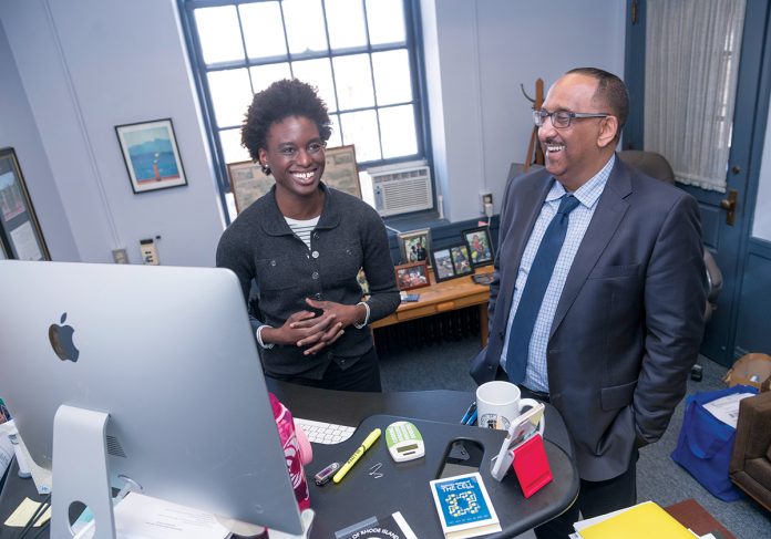 PROACTIVE: Nasser Zawia, dean of the University of Rhode Island Graduate School, speaks with Alycia Mosley Austin, associate director, interdisciplinary neuroscience program associate dean, recruitment and diversity initiatives. Zawia and other administrators sent welcoming messages to international student applicants to counter the unwelcoming messages from the Trump administration. / PBN PHOTO/MICHAEL SALERNO