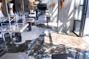 2010: Dennis Martin, executive general adjuster at William Kramer & Associates Property and Casualty Adjusters, assesses water damage at the NYLO Providence Warwick hotel in Warwick after the March 2010 floods. / PBN FILE PHOTO/FRANK MULLIN