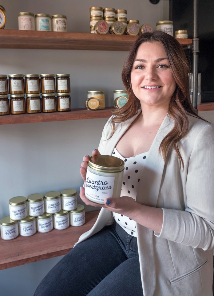 SCENTED CANDLES: Catherine Kwolek is the owner of Aster Candle, a recently launched homemade-candle business in Lincoln. Her coffee milk scented jar candle is a best-seller. / PBN PHOTO/MICHAEL SALERNO