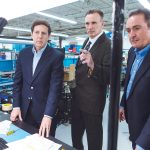 SUPPLY AND COMMAND: From left, AstroNova CEO Gregory Woods, Purchasing Manager James McGovern and Vice President of Instrument Manufacturing Stephen Petrarca review the company’s new vendor-owned/managed inventory system. / PBN PHOTO/RUPERT WHITELEY