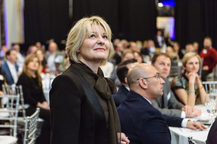 TIA BUSH, vice president of site operations for Amgen Rhode Island, waits to address attendees at PBN's fifth Manufacturing Awards event, held at WaterFire Providence Thursday. / PBN PHOTO/RUPERT WHITELEY