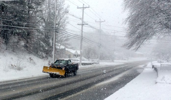 HOPKINS HILL ROAD in Coventry was beginning to be covered in snow despite the efforts of plow trucks early on Tuesday. The nor'easter that is hitting New England is still expected to dump upwards of a foot of show or more in the region. / PBN PHOTO/ROB BORKOWSKI