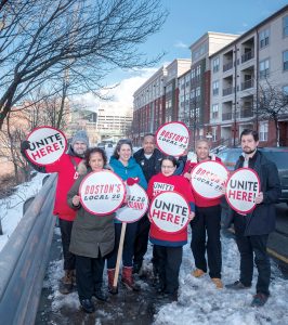 UNITED ADVOCATES: Members of Unite Here Local 26, which advocates for better wages for workers, outside of the 903 apartment building they protested in front of several months ago. The group is opposed to the tax-stabilization agreement proliferation because it promotes development of costly living units. From left, Jeyson Gomez, Juana Cabrera, Jenna Karlin, Hipolito Rivera, Gina Vasconez, Raquel Cruz and Jonah Zinn.  / PBN PHOTO/MICHAEL SALERNO