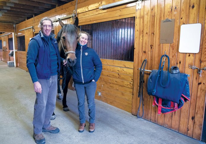 EQUINE CARE: Ocean State Equine Associates owners and veterinarians Dr. Enda Currid, left, and Dr. Hollie Stillwell with Lady, a 15-year-old Dutch Warmblood. The equine veterinary practice in Scituate offers routine wellness care, emergency medicine and equine surgery in Rhode Island, Massachusetts and surrounding areas.  / PBN PHOTO/MICHAEL SALERNO