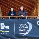 BANNER EVENT: Sail Newport Executive Director Brad Read, this year’s Volvo Ocean Race stopover executive director, and Sue Maffei Plowden, race event director, stand on the porch of the Sail Newport Sailing Center with the banner for Volvo Ocean Race Newport. The city is the lone North American stopover for the 2017-18 international race.  / PBN PHOTO/ KATE WHITNEY LUCEY