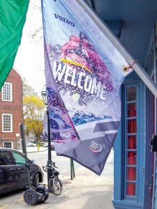GETTING INVOLVED: A welcome flag hangs outside a Newport storefront during the Volvo Ocean Race stopover in May 2015.  / COURTESY SAIL NEWPORT