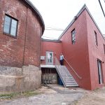 NECESSARY STEPS: On the building’s exterior, new stairs and a new entrance leading into the building were constructed in an alley in between the triangular building and the rotunda that was once fenced off. / PBN PHOTO/MICHAEL SALERNO