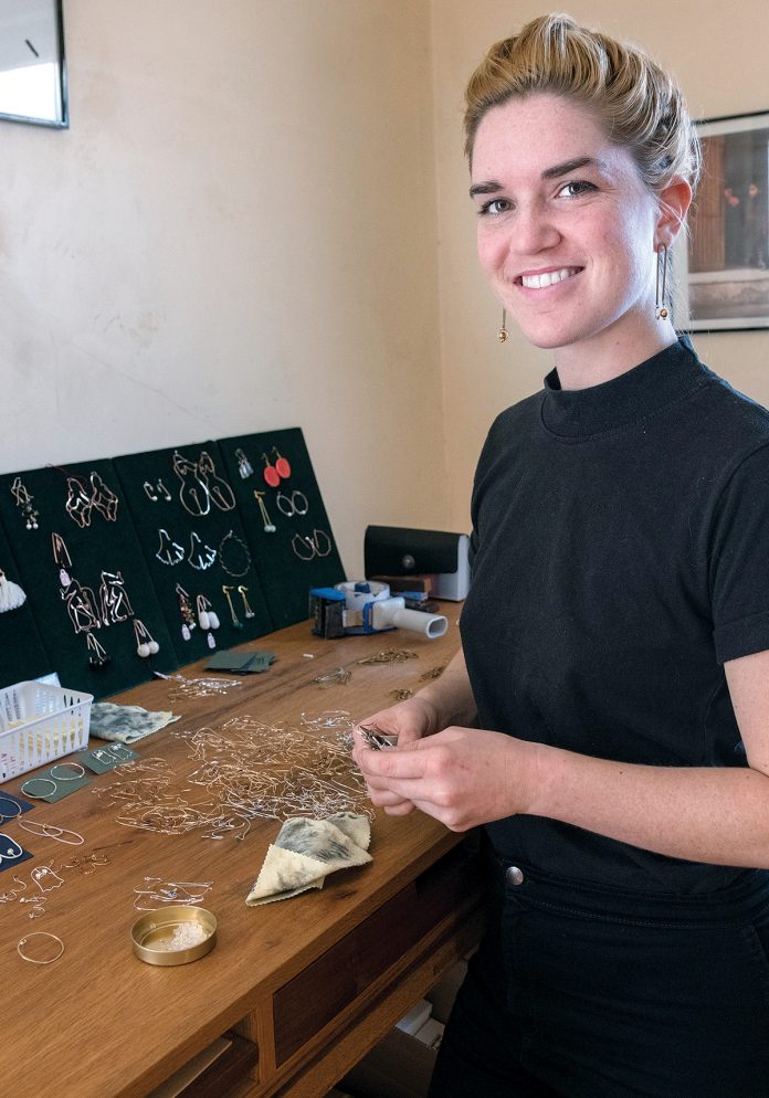 ARTISTIC TOUCH: Rhode Island School of Design alumna Julia Sullivan is the owner of Providence-based RA HA Jewelry. She describes her earrings, below, as “art for your ears.” / PBN PHOTOS/MICHAEL SALERNO