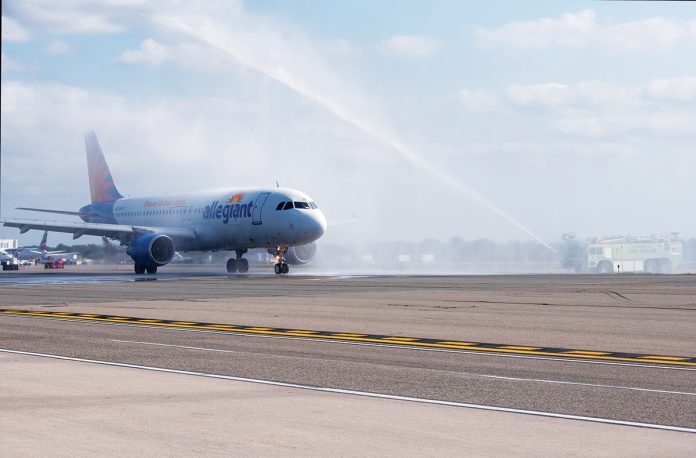 WELCOMING ALLEGIANT: A fire engine shoots a stream of water into the air in celebration of the first flight of Allegiant Air to T.F. Green Airport in September. / PBN PHOTO/MICHAEL SALERNO