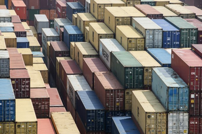THE TRADE CONFLICT between the United States and China, the two largest economies in the world, appears to be easing. Shipping containers stand in a terminal at the Yangshan Deep Water Port in Shanghai in March. / QILAI SHEN/BLOOMBERG NEWS PHOTO