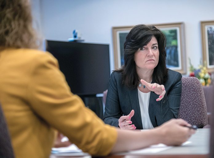 OBSTACLE JUMPER: Lisa Dandeneau, chief operating officer of Navigant Credit Union, meets with Eliza Lavergne, vice president, project management, at the credit union’s Smithfield office. / PBN PHOTO/RUPERT WHITELEY