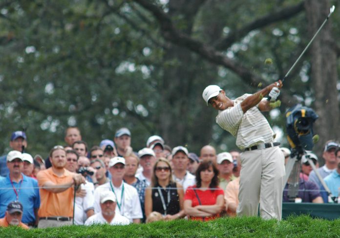 IN 2016, AMERICA counted only 23.8 million golfers, down from its peak of 30.6 million in 2003, according to the National Golf Foundation. Above, Tiger Woods hits his tee shot on 13 at the PGA Championship in Medinah, Ill. in 2006. / BLOOMBERG FILE PHOTO/JOE TABACCA