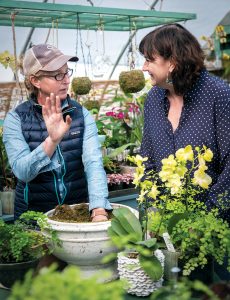 GREEN THUMB: Sara Partyka, left, owner of The Farmer’s Daughter in South Kingstown, speaks with Rhode Island Nursery and Landscape Association Executive Director Shannon Brawley. / PBN PHOTO/MICHAEL SALERNO