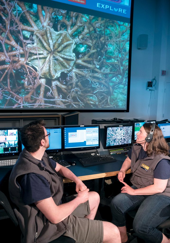 0518cover IN SEARCH OF INNOVATION: The Universiry of Rhode Island's Bay Campus in Narragansett is the home of the Ocean Science Exploration Center and the Inner Space Center. They form the core of one of 16 projects that the state is considering for innovation hubs connected to URI. From left, Kyle Sidlik, media production, Holly Morin, marine biologist and education specialist, in the Inner Space Center. PBN FILE PHOTO/MICHAEL SALERNO