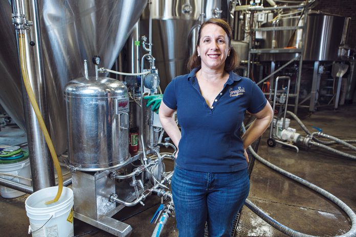 SPIRITED CULTURE: Jennifer Brinton, co-owner of Grey Sail Brewing of Rhode Island in Westerly, strives to maintain a family atmosphere and culture at the brewery. / PBN PHOTO/RUPERT WHITELEY