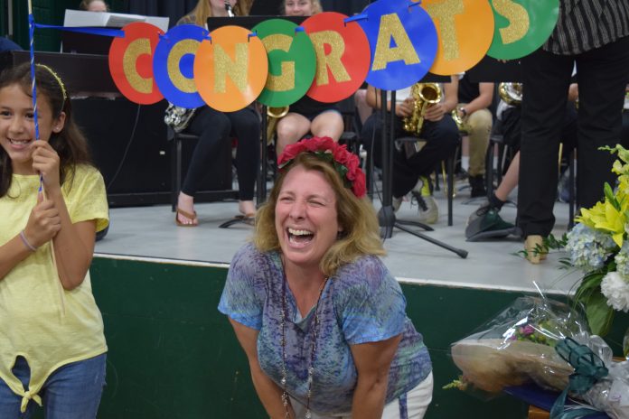 JAMESTOWN SIXTH-GRADE TEACHER Charlene Tuttle celebrates being named the 2019 Rhode Island Teacher of the Year Wednesday at a surprise announement at the Lawn School. / COURTESY R.I. DEPARTMENT OF EDUCATION