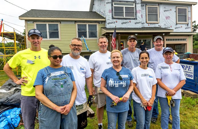 HOUSING HANDS: Town Dock employees volunteer with Habitat for Humanity to renovate a house in the Bradford village of Westerly last August. COURTESY THE TOWN DOCK / COURTESY THE PROVIDENCE MUTUAL FIRE INSURANCE CO.