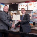 GRAND OPENING: DQ Grill and Chill co-owner Will Dailey, left, receives an official certificate from Cranston Mayor Allan Fung celebrating the grand opening of the restaurant. / PBN PHOTO/MICHAEL SALERNO