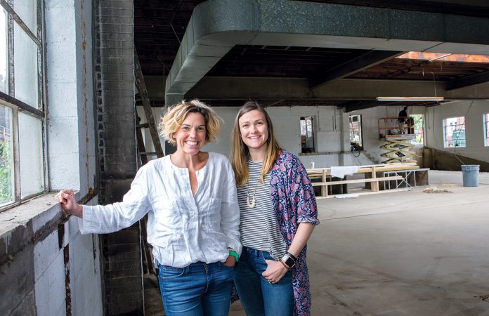 NEW SETUP: E. Frances Paper owners Jenni Laundon, left, director of sales, and Emily Roberts, director of operations, in what will be the new product assembly area for the greeting card and stationery design and manufacturer. The company currently leases space in Newport but will move in July to a new location, above, it purchased in Middletown. / PBN PHOTO/KATE WHITNEY LUCEY