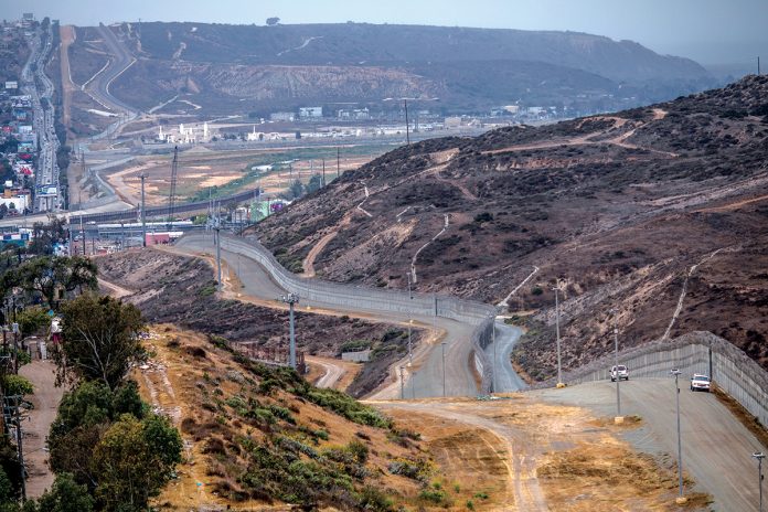 A WALL GROWS: The existing U.S.-Mexico border wall in Tijuana, Mexico, is only a physical manifestation of the growing wall in the local body politic over the nation’s immigration policies and enforcement.   / BLOOMBERG  NEWS PHOTO/ ALEJANDRO CEGARRA