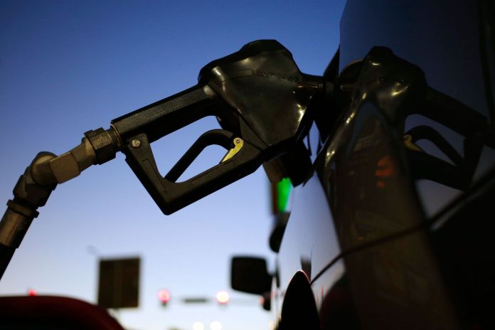 BOTH RHODE ISLAND and Massachusetts regular gas prices declined 2 cents this week. / BLOOMBERG FILE PHOTO/LUKE SHARRETT