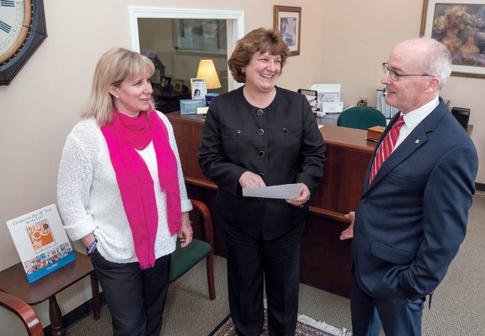 BALMY CLIMATE: Edward Jones’ goal is to provide employees the discretion to meet clients’ needs using their own judgment. From left, Barrington office members Amy Gomes and Brenda Novak, senior branch office administrators, and John Leary, financial adviser, regional leader and principal. / PBN PHOTO/RUPERT WHITELEY