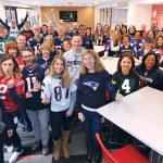 BUILT FOR SUCCESS: Gilbane employees show off their NFL team pride during the company’s show-your-colors day. / COURTESY GILBANE INC.