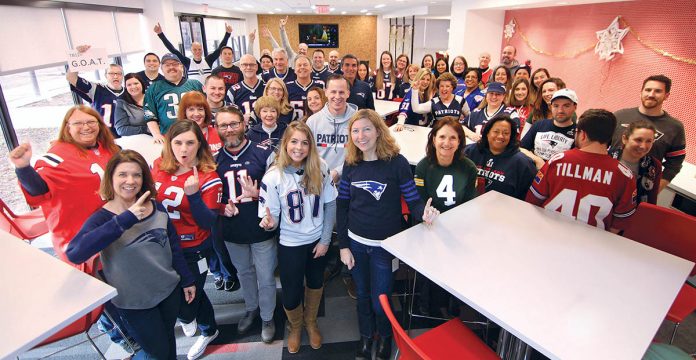 BUILT FOR SUCCESS: Gilbane employees show off their NFL team pride during the company’s show-your-colors day. / COURTESY GILBANE INC.