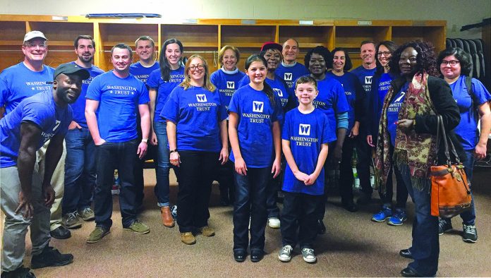 TURKEY TIME: Washington Trust employees volunteer at the Pawtucket Thanksgiving Basket Drive in November, helping to assemble food boxes.  / COURTESY THE Washington Trust Co.