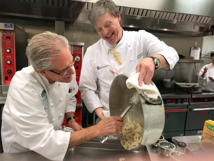 ROLLIE WESEN, right, co-founder and chief operations officer of the Jacques Pépin Foundation and a culinary professor at Johnson & Wales cooks with with Chef Ron Lewis, left, instructor with the Food Bank’s Community Kitchen program. / COURTESY RHODE ISLAND FOOD BANK