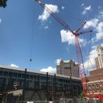 A 240-FOOT CRANE installs structural steel beams at the Residence Inn hotel site in Providence this week, marking the beginning of vertical construction, which is expected to continue through the summer. / PBN FILE PHOTO/CHRIS BERGENHEIM