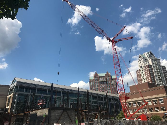 A 240-FOOT CRANE installs structural steel beams at the Residence Inn hotel site in Providence this week, marking the beginning of vertical construction, which is expected to continue through the summer. / PBN FILE PHOTO/CHRIS BERGENHEIM