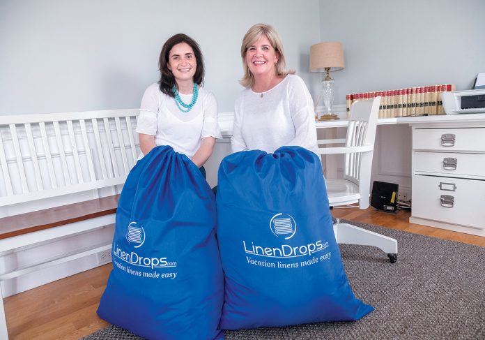 HEAVY LOAD: Rosa Ciunci, left, and Maureen Pagliaro, co-founders of LinenDrops.com, provide linen services for vacation and short-term rental properties throughout the region.  / PBN PHOTO/MICHAEL SALERNO