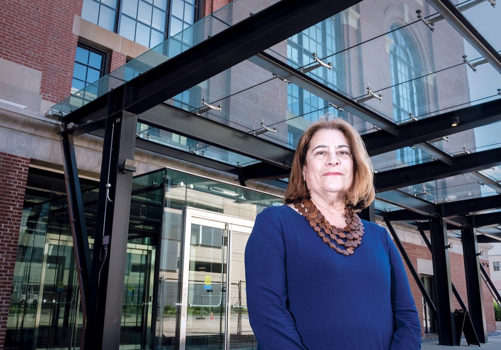 REVITALIZED DISTRICT: Sharon Steele, president of the Jewelry District Association, stands in front of the entrance to South Street Landing in Providence. Steele says the influx of educational institutions into the district has “brought incredible revitalization, energy, activity and demand for services.”  / PBN PHOTO/MICHAEL SALERNO