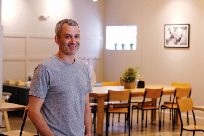 AGGRESSIVE GROWTH: Adam Lastrina, co-owner of Knead Doughnuts, is pictured at the company’s newest location at 135 Elmgrove Ave. on the East Side in Providence, which opened in April. The company opened its first location in downtown Providence in December 2016 and hopes to open four locations within five years.  / PBN PHOTO/KATE TALERICO